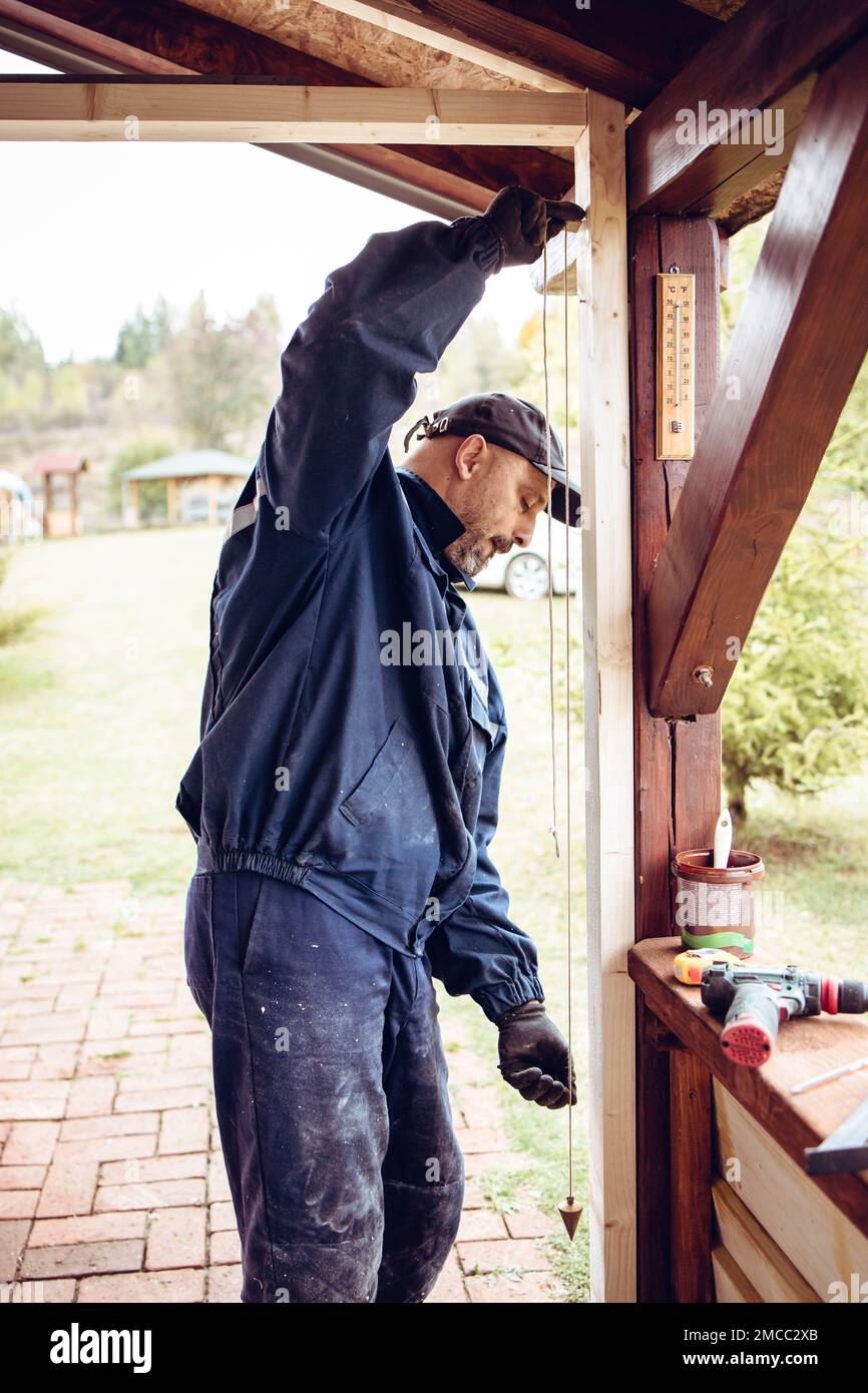 Handyman working with a pendulum, construction tool Stock Photo