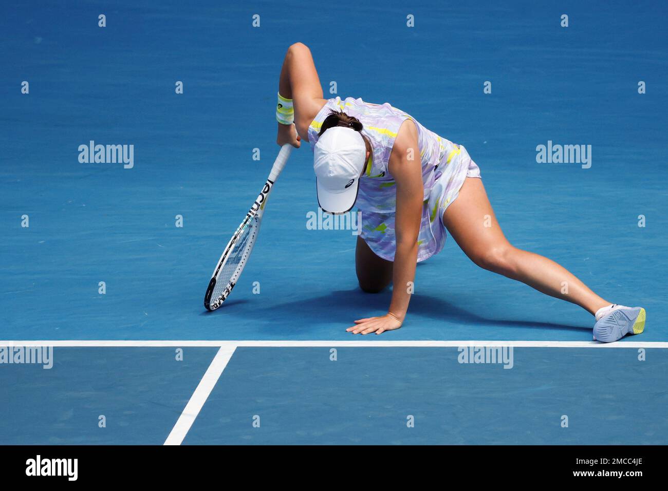 Iga Swiatek of Poland falls to the court during her quarterfinal against Kaia Kanepi of Estonia at the Australian Open tennis championships in Melbourne, Australia, Wednesday, Jan