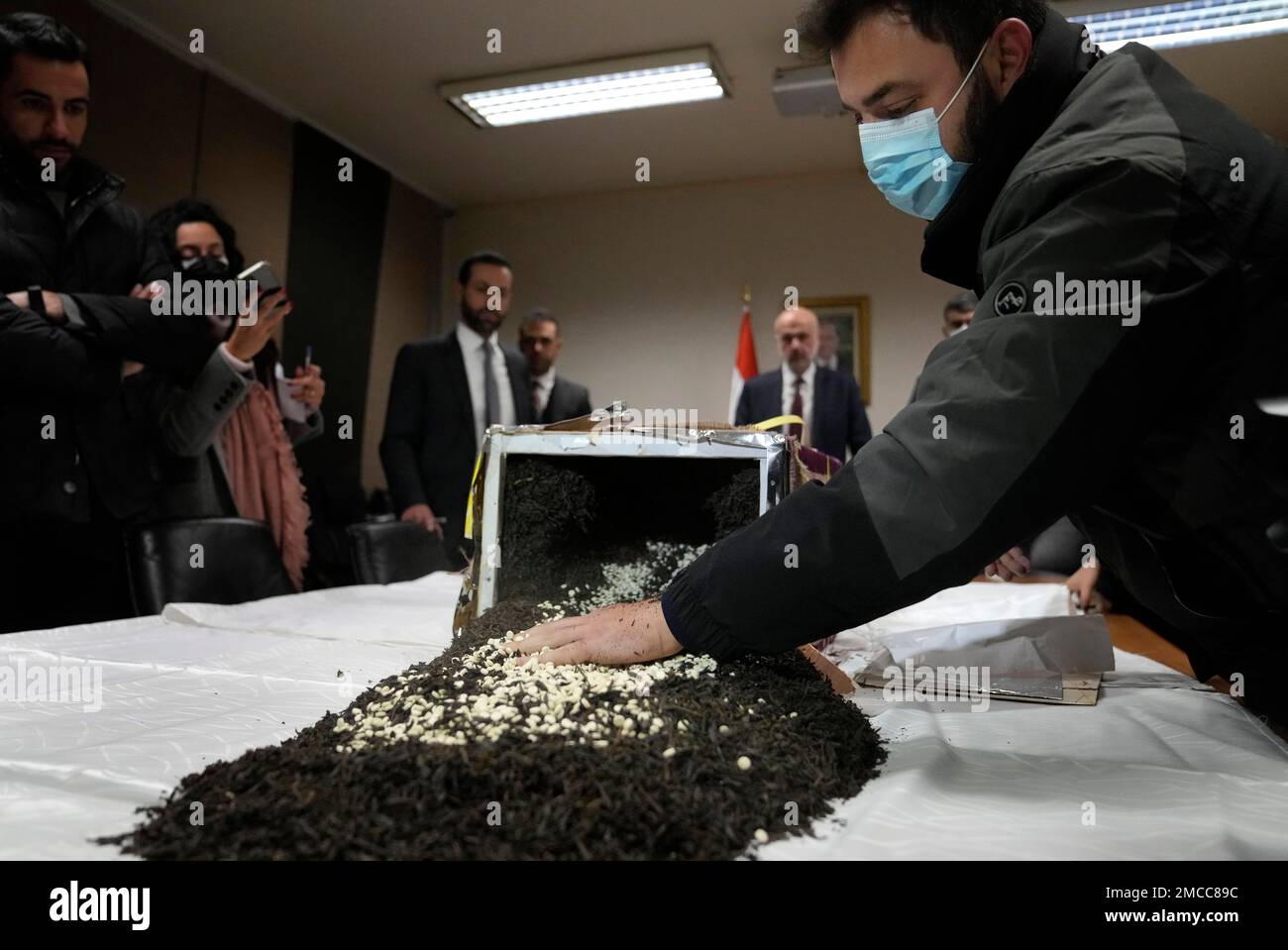 A security officer displays confiscated amphetamine Captagon pills which were hidden in 434 boxes mixed with seven tons of tea for export, at the Lebanese police headquarters, in Beirut, Lebanon, Tuesday, Jan. 25, 2022. Interior Minister Bassam Mawlawi said Lebanon's police intelligence thwarted the attempt to smuggle large amounts of Captagon that were on their way from Lebanon to the African nation of Togo to be sent from there to a Persian gulf nation, most likely Saudi Arabia. (AP Photo/Hussein Malla) Stock Photo