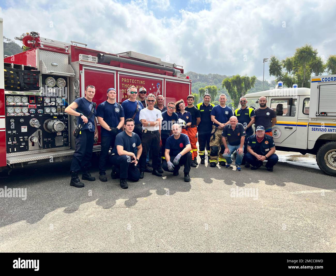 220629-N-XS877-6546 NAVAL SUPPORT ACTIVITY NAPLES, Italy (June 29, 2022)   Naval Support Activity Naples’ Fire and Emergency Services members pose with Italian firefighting authorities after extinguishing fires in the area surrounding Carney Park in Pozzuoli, Italy, on June 29, 2022. NSA Naples is an operational ashore base that enables U.S., allied, and partner nation forces to be where there are needed, when they are needed to ensure security and stability in the European, African, and Central Command areas of responsibility. Stock Photo