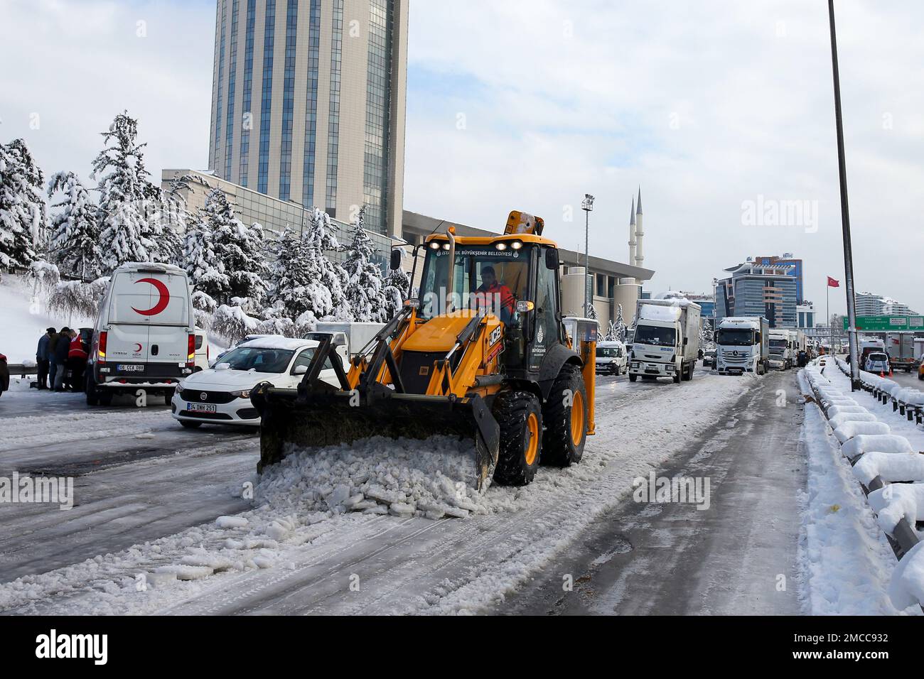 Mayoral workers work to open a main road at Istanbul, Tuesday, Jan. 25,  2022. Rescue crews in Istanbul and Athens scrambled on Tuesday to clear  throughways that came to a standstill after