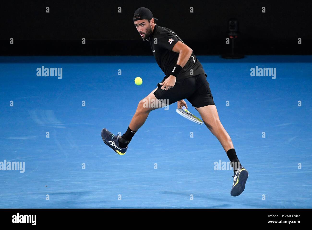 Matteo Berrettini of Italy plays a shot between his legs to Gael Monfils of France during their quarterfinal match at the Australian Open tennis championships in Melbourne, Australia, Tuesday, Jan