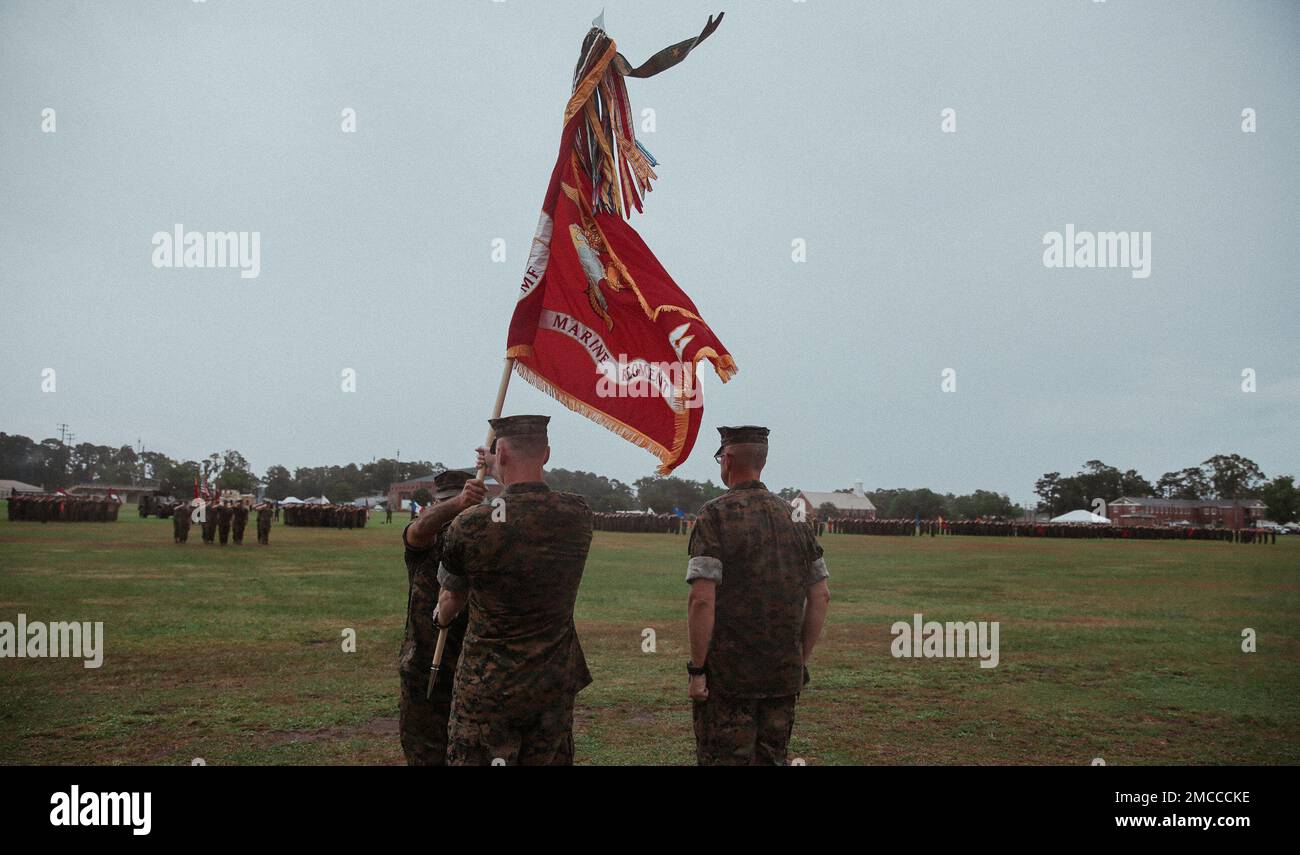 U.S. Marine Corps Col. Gregory P. Gordon, left, the incoming commanding officer of 6th Marine Regiment, 2d Marine Division, passes the regimental colors to Sgt. Maj. Giovanni A. Lobo, the regimental sergeant major, at a change of command ceremony on Camp Lejeune, North Carolina, June 29, 2022. During the ceremony, Col. Jeffrey R. Kenney, the outgoing regimental commander of 6th Marines, relinquished command to Col. Gregory P. Gordon. Stock Photo