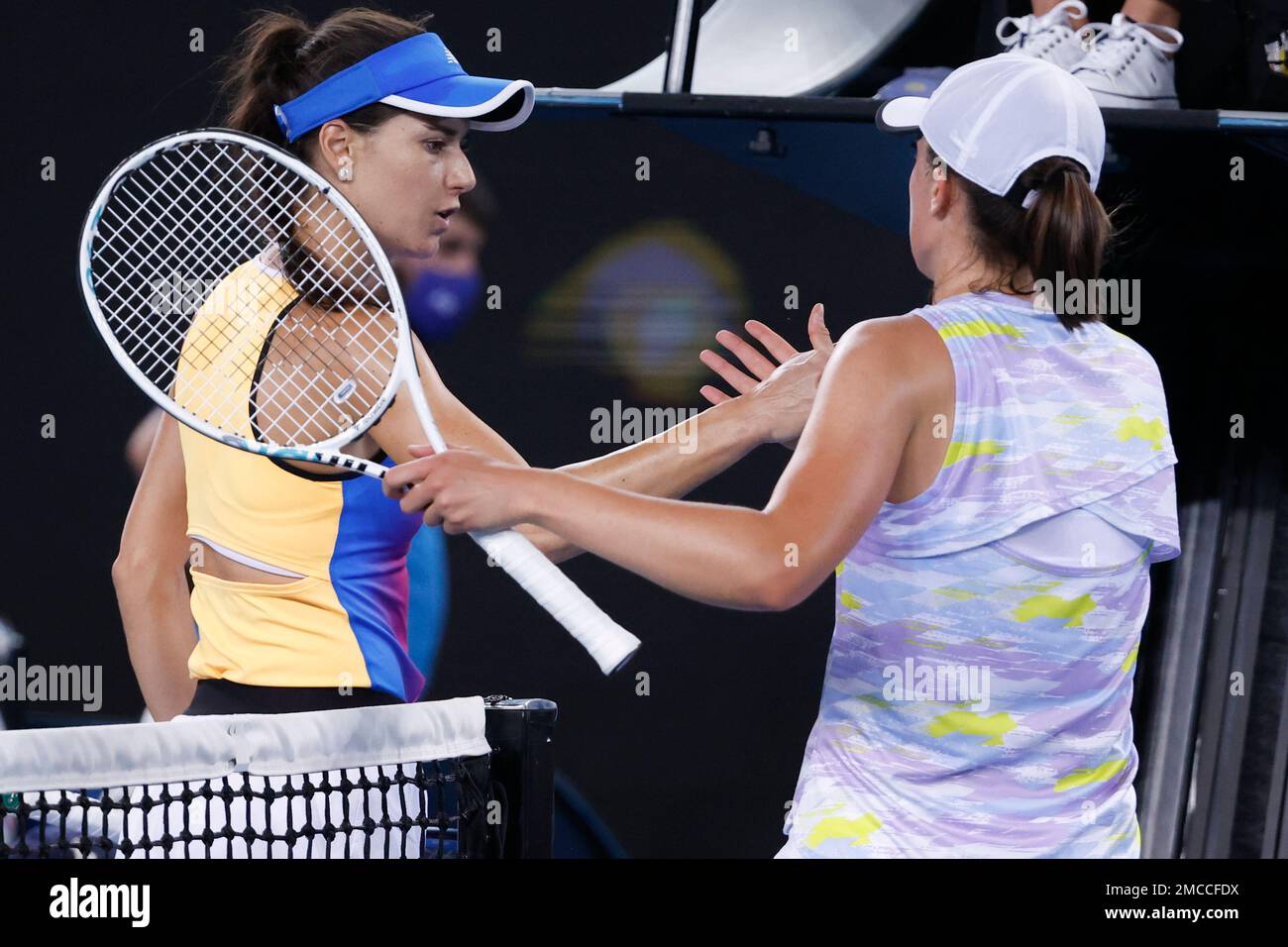 Iga Swiatek, right, of Poland is congratulated by Sorana Cirstea of Romania following their fourth round match at the Australian Open tennis championships in Melbourne, Australia, Monday, Jan