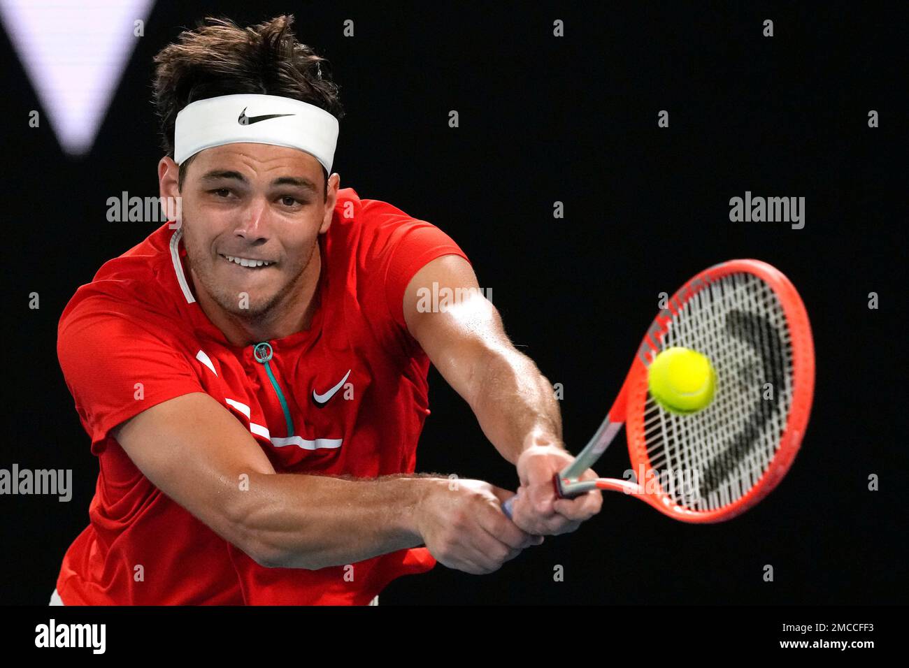 Taylor Fritz of the U.S. makes a backhand return to Stefanos Tsitsipas of Greece during their fourth round match at the Australian Open tennis championships in Melbourne, Australia, Monday, Jan