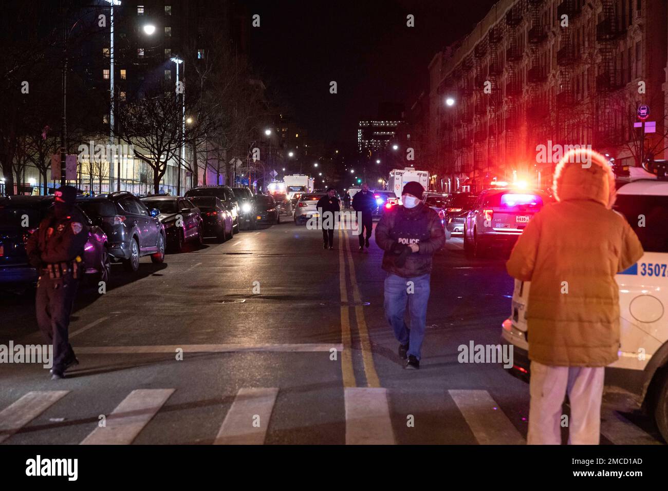 NYPD officers are seen at the scene of shooting in Harlem on Friday ...