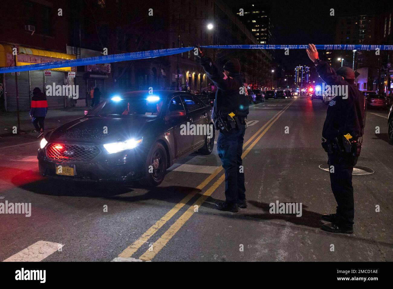 NYPD officers are seen at the site of a shooting in Harlem on Friday ...