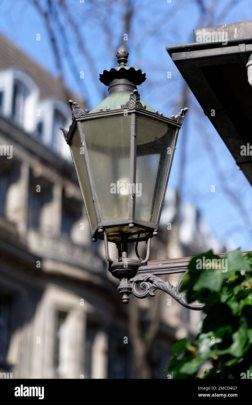 old-fashioned streetlamp in front of blurred background in cologne old town Stock Photo
