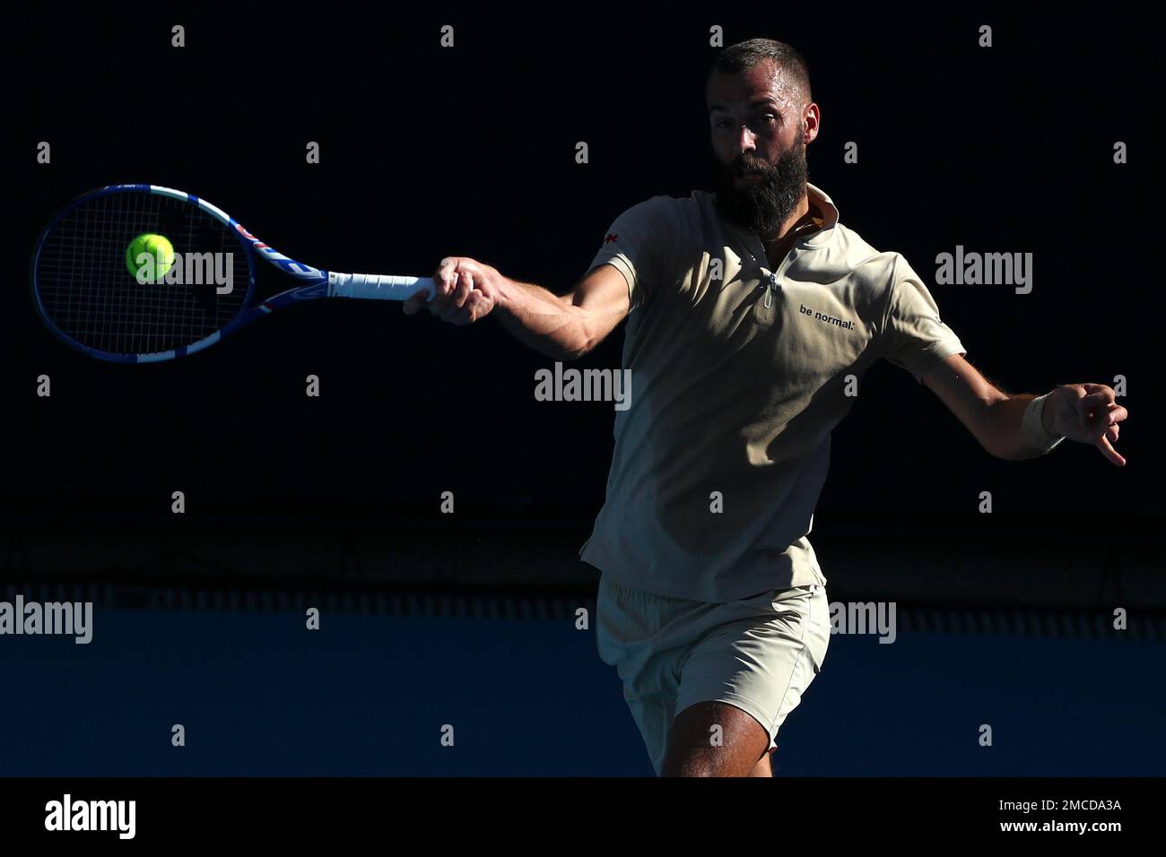 Benoit Paire of France plays a forehand return to Grigor Dimitrov of Bulgaria during their second round match at the Australian Open tennis championships in Melbourne, Australia, Thursday, Jan