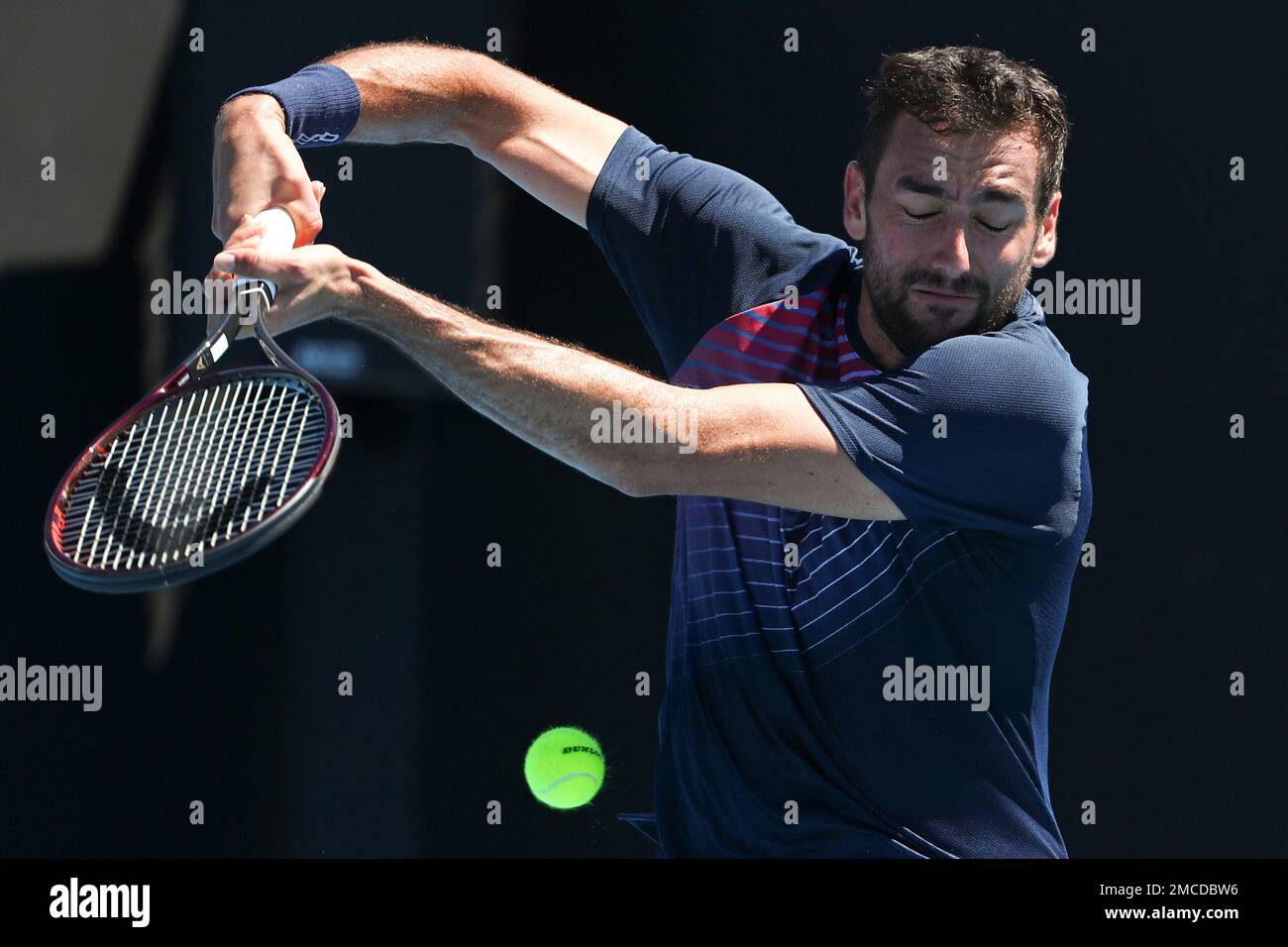 Marin Cilic of Croatia plays a backhand return to Norbert Gombos of Slovakia during their second round match at the Australian Open tennis championships in Melbourne, Australia, Thursday, Jan