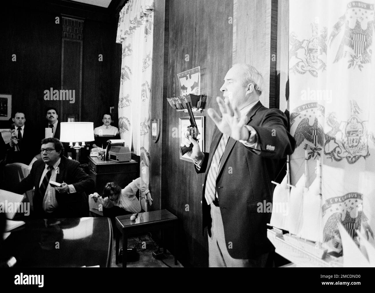 Pennsylvania State Treasurer R. Budd Dwyer, raises his left hand to(02)
