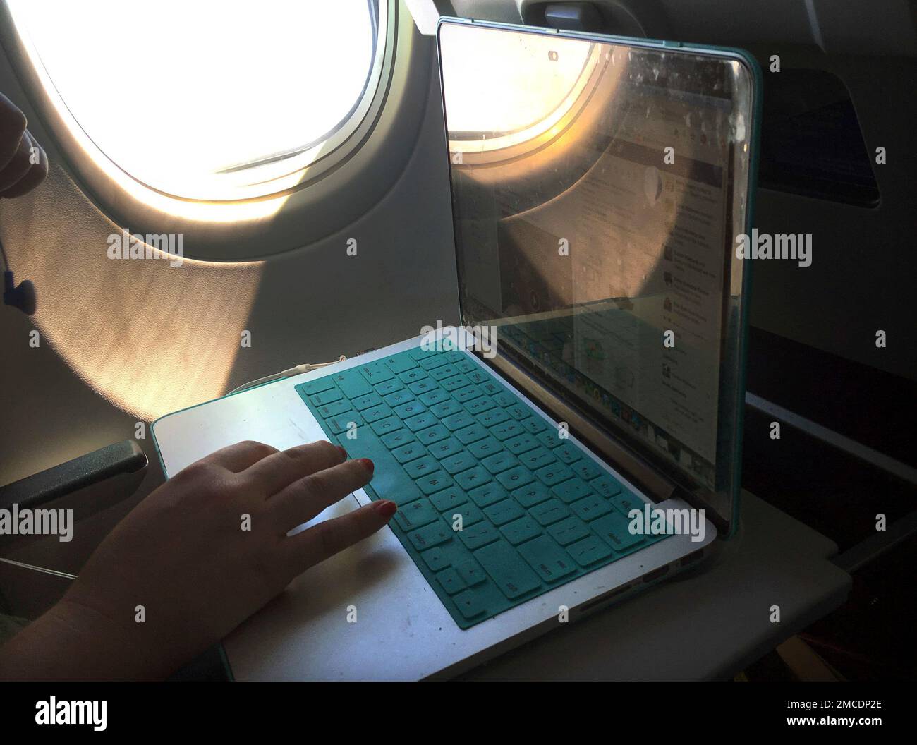 FILE A passenger uses a laptop aboard a commercial airline flight