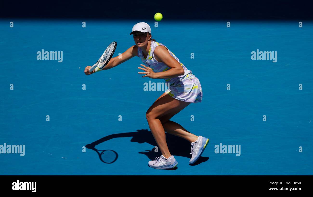 Iga Swiatek of Poland plays a forehand return to Harriet Dart of Britain during their first round match at the Australian Open tennis championships in Melbourne, Australia, Tuesday, Jan