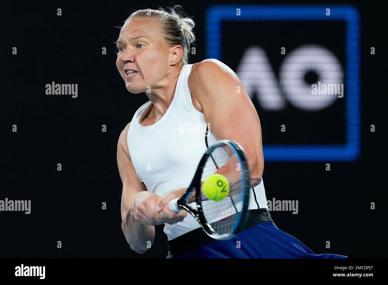 Kaia Kanepi of Estonia plays a backhand return to Angelique Kerber of Germany during their first round match at the Australian Open tennis championships in Melbourne, Australia, Tuesday, Jan