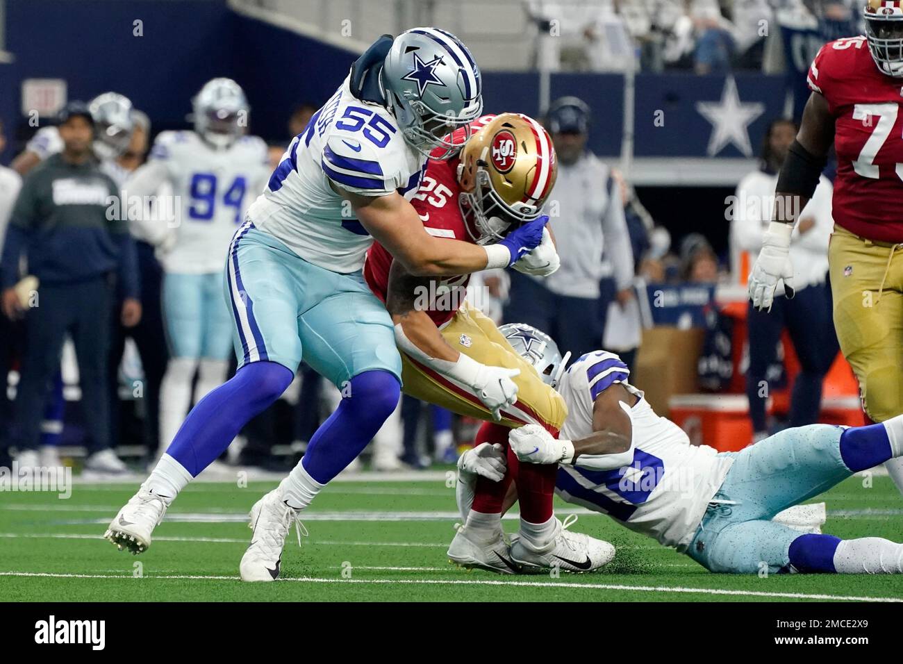 Dallas Cowboys outside linebacker Leighton Vander Esch (55) helps free  safety Damontae Kazee (18) make a stop against San Francisco 49ers running  back Elijah Mitchell (25) in the first half of an