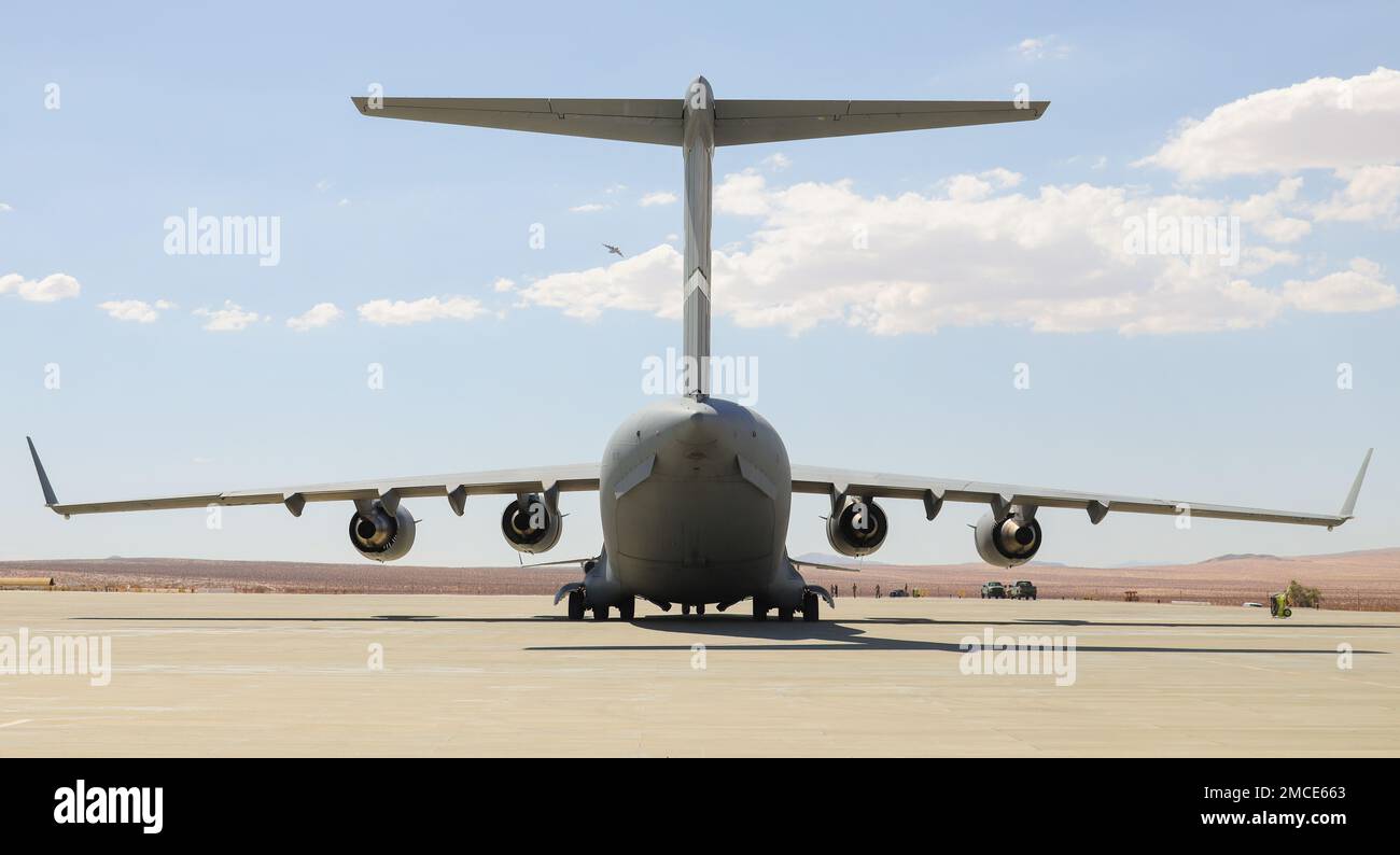 A U.S Air Force C-17 Globemaster III aircraft with the 21st Airlift Squadron, 60th Air Mobility Wing (AMW) lands at the Strategic Expeditionary Landing Field for joint exercise Patriot Hook at Marine Corps Air Ground Combat Center, Twentynine Palms, California, June 29, 2022. Air Force 60th AMW delivered Marine Corps UH-1Y Venom helicopters and AH-1Z Viper helicopters to conduct strike missions, testing Marine Light Attack Helicopter Squadron 267 (HMLA-267) rapid deployment capabilities. Stock Photo