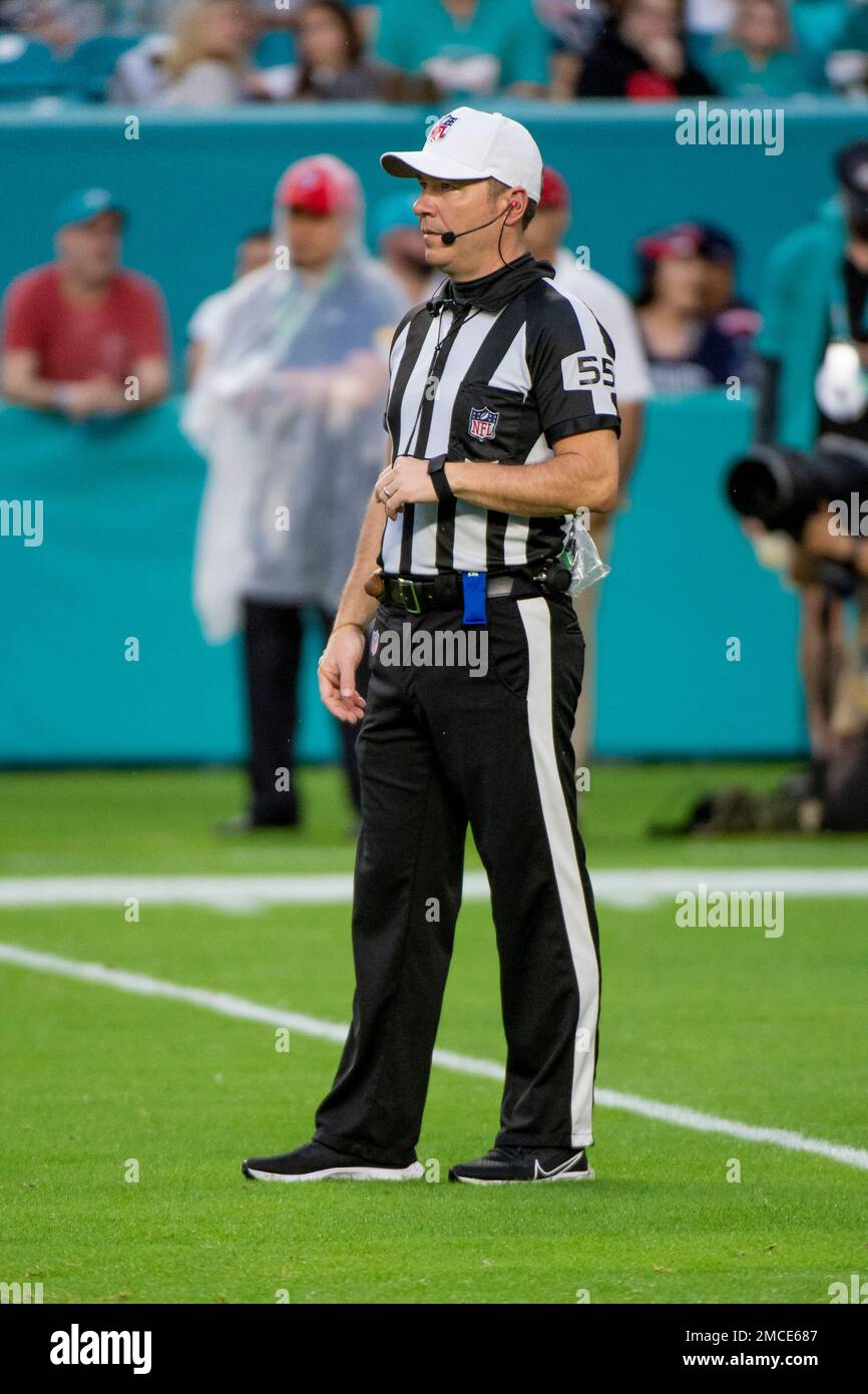 NFL referee Alex Kemp stands on the field during an NFL football game
