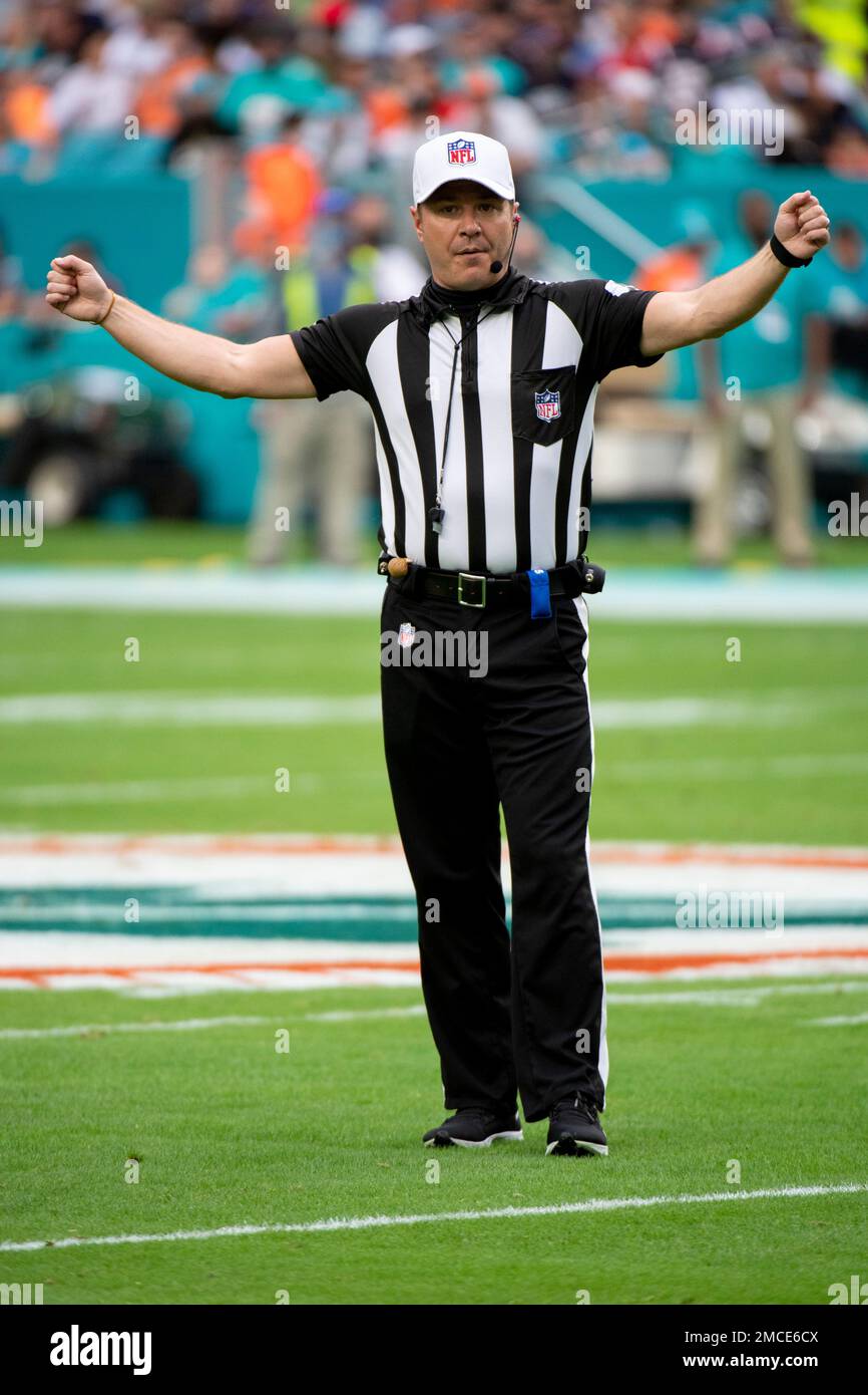 NFL referee Alex Kemp gestures on the field during an NFL football game