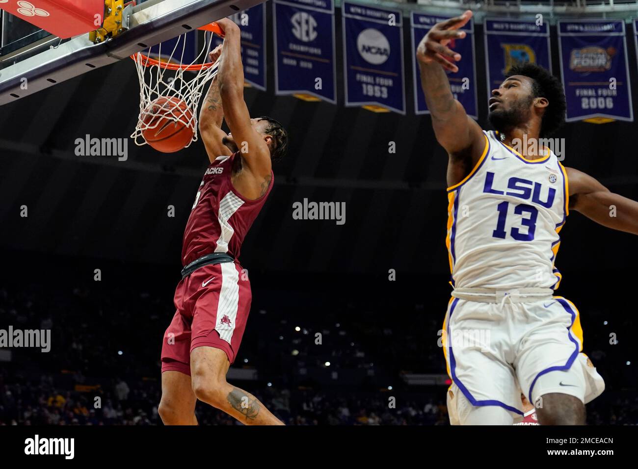 Arkansas guard Au'Diese Toney (5) slam dunks against LSU forward Tari Eason (13)in the first