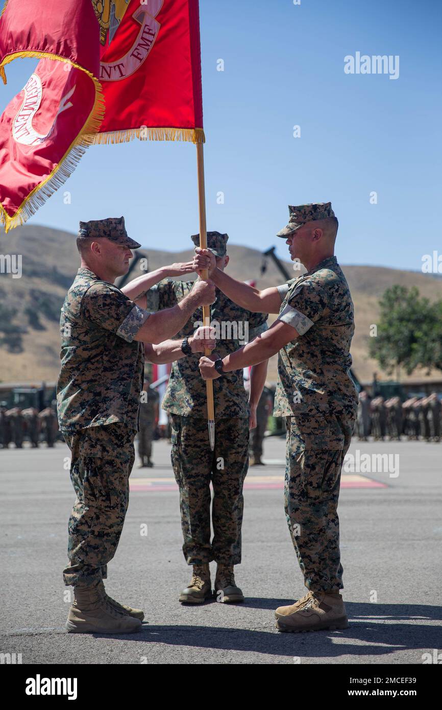 U.S. Marine Corps Col. Patrick Eldridge (left), the incoming commanding officer of 11th Marine Regiment, 1st Marine Division, receives the unit colors from Col. Daniel Skuce (right), the outgoing commanding officer of 11th Marine Regiment during a change of command ceremony at Marine Corps Base Camp Pendleton, California, June 30, 2022. During the ceremony, Skuce relinquished command of 11th Marine Regiment to Eldridge. Stock Photo