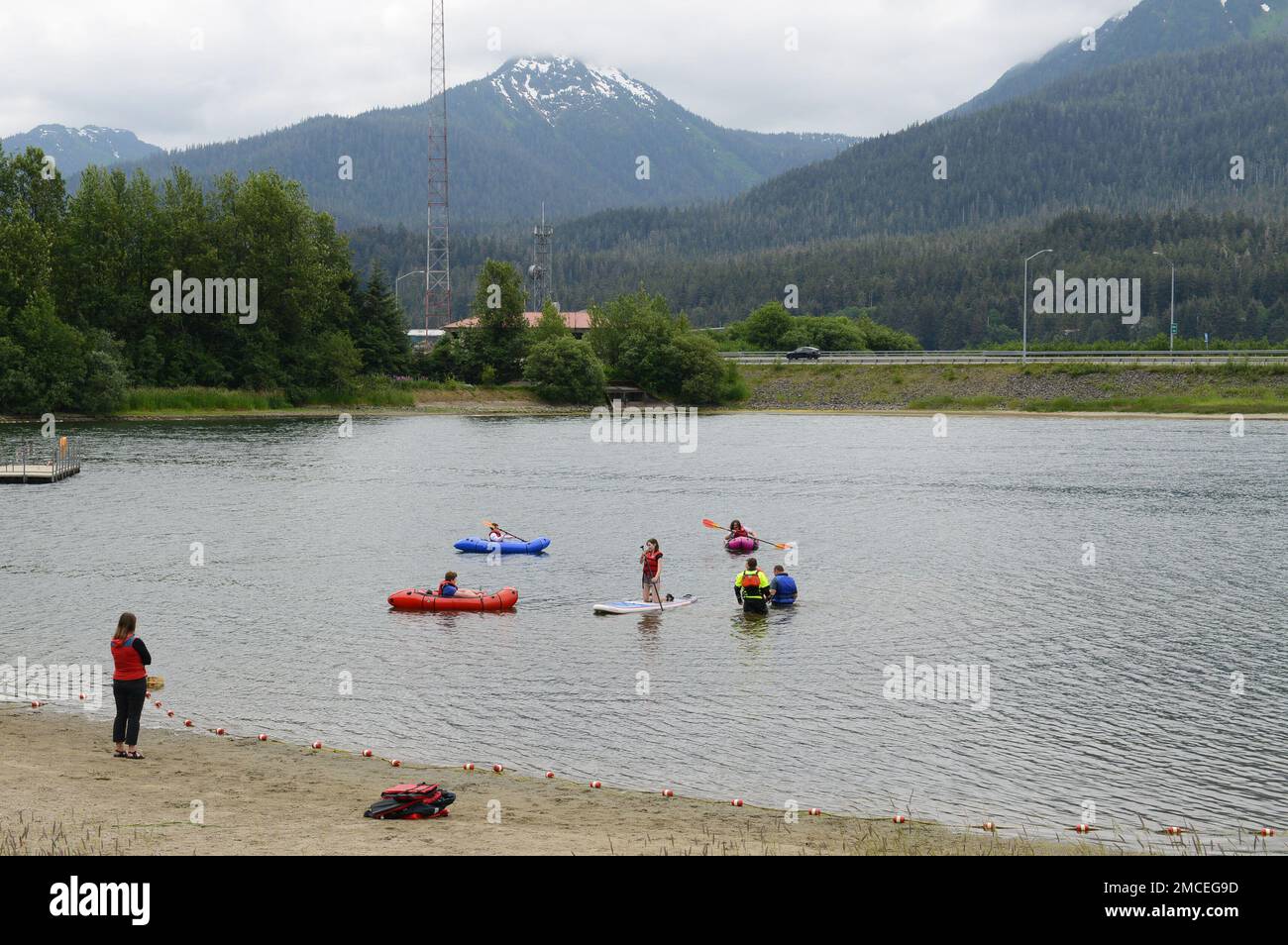 Coast Guard personnel teaching children how to use paddle craft at Twin