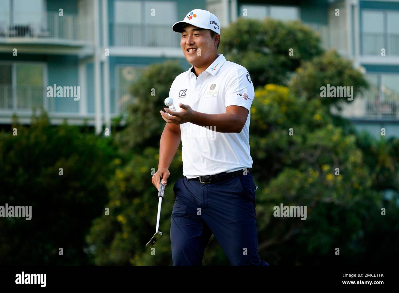 K.H. Lee, of South Korea, flips his ball on the 10th green during the