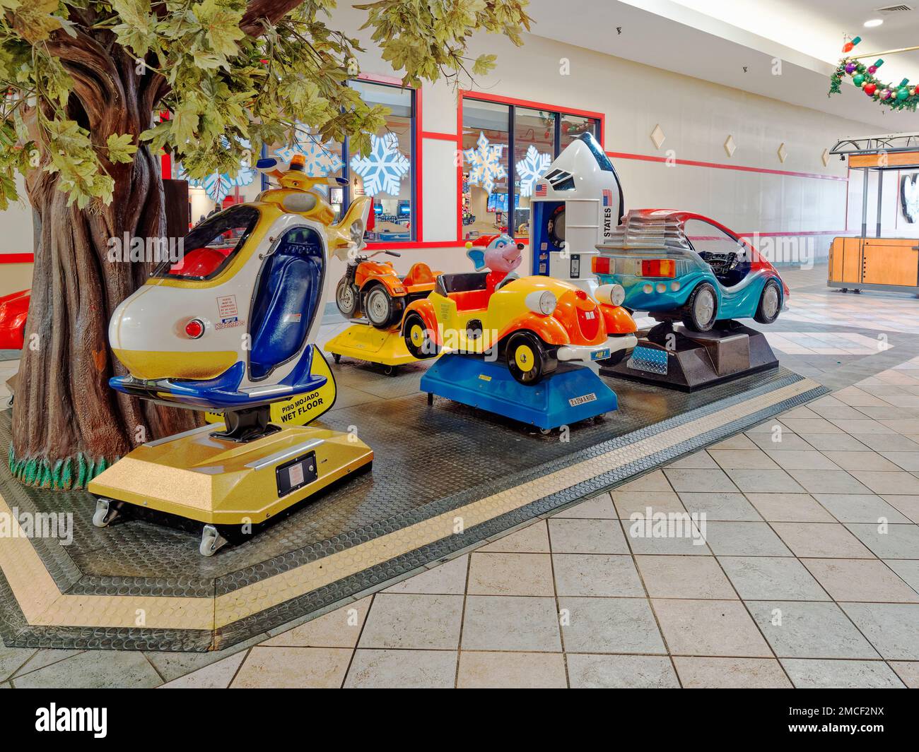 Child's or children's coin operated amusement rides at an indoor playground for children in a mall in Montgomery Alabama, USA. Stock Photo