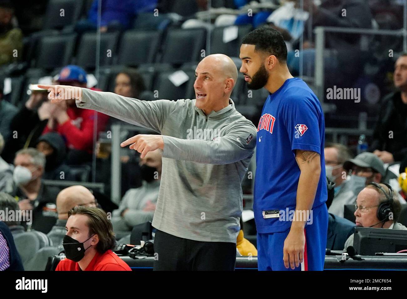 Detroit Pistons assistant coach Rex Kalamian talks with guard Cory