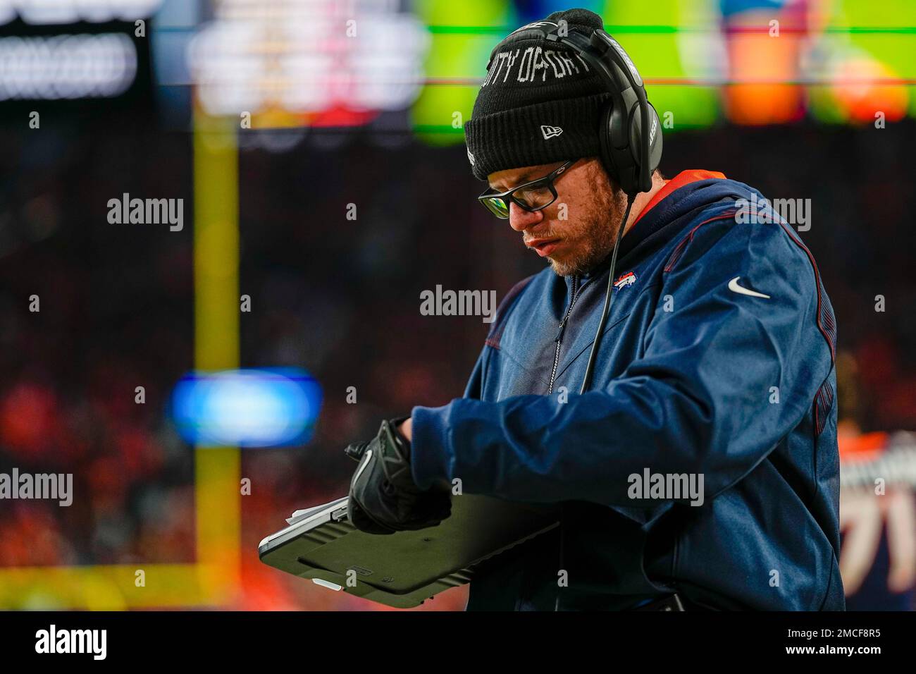 Denver Broncos' Mateo Kambui, Marlin Briscoe Diversity Coaching Fellow,  looks on against the Kansas City Chiefs during an NFL football game  Saturday, Jan. 8, 2022, in Denver. (AP Photo/Jack Dempsey Stock Photo -