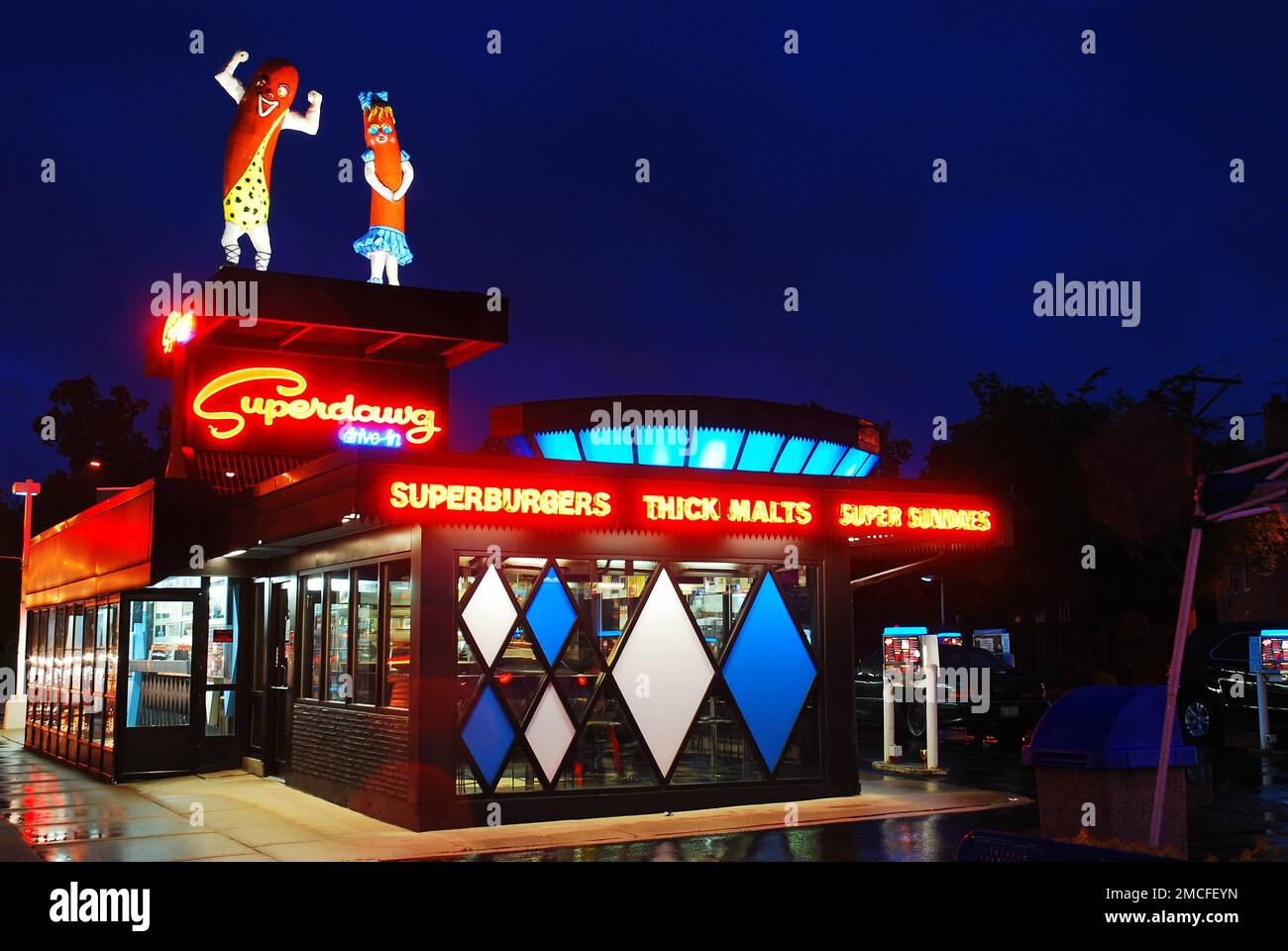 Two large Hot dogs stand atop Superdawg, one of Chicago's legendary hot dog stands Stock Photo
