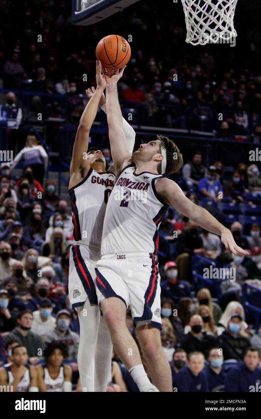 Gonzaga guard Julian Strawther (0) and forward Drew Timme (2) go after a rebound during the first half of an NCAA college basketball game against Pepperdine, Saturday, Jan. 8, 2022, in Spokane, Wash. (AP Photo/Young Kwak) Stock Photo