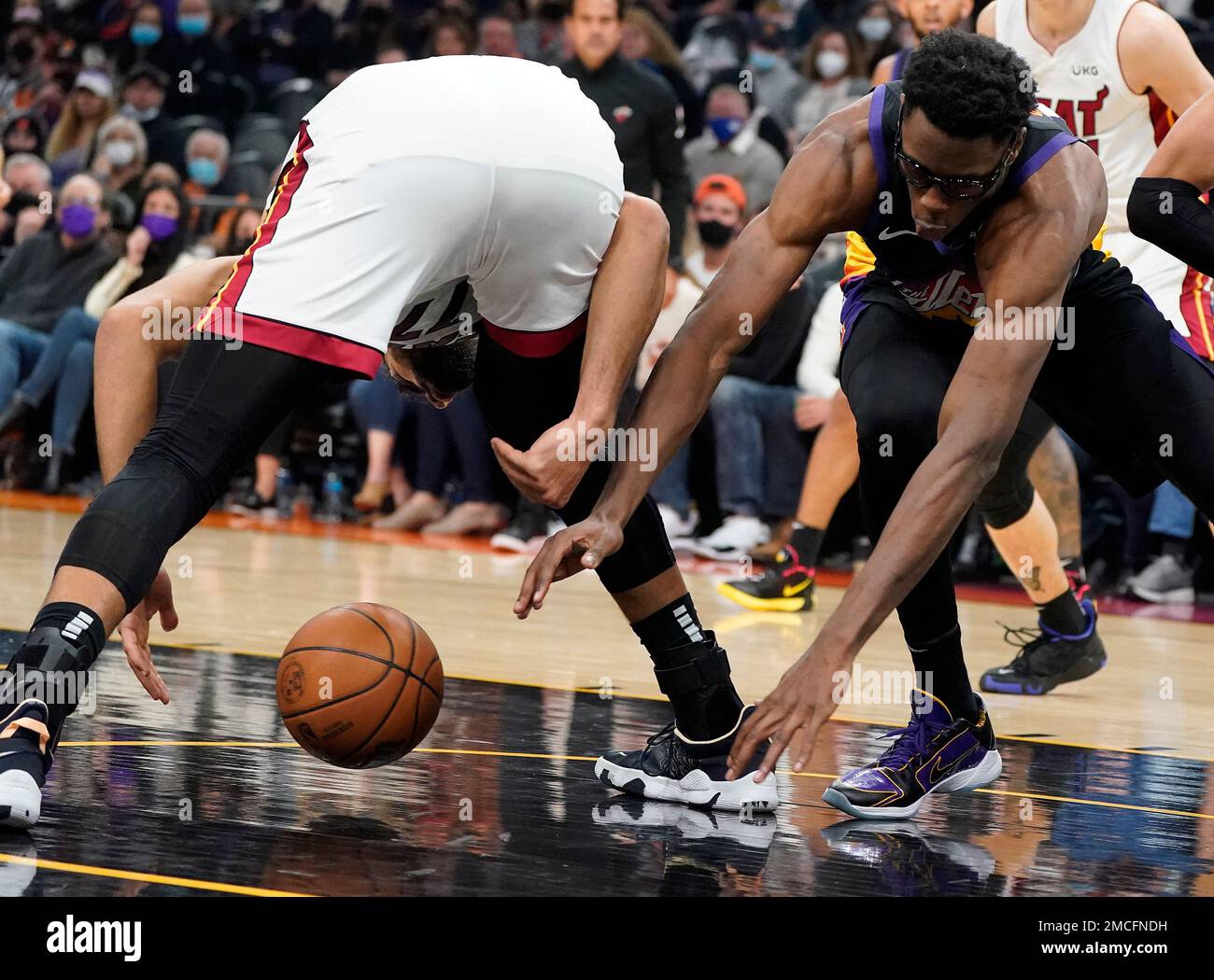 Miami Heat's Omer Yurtseven, right, get the rebound ahead of