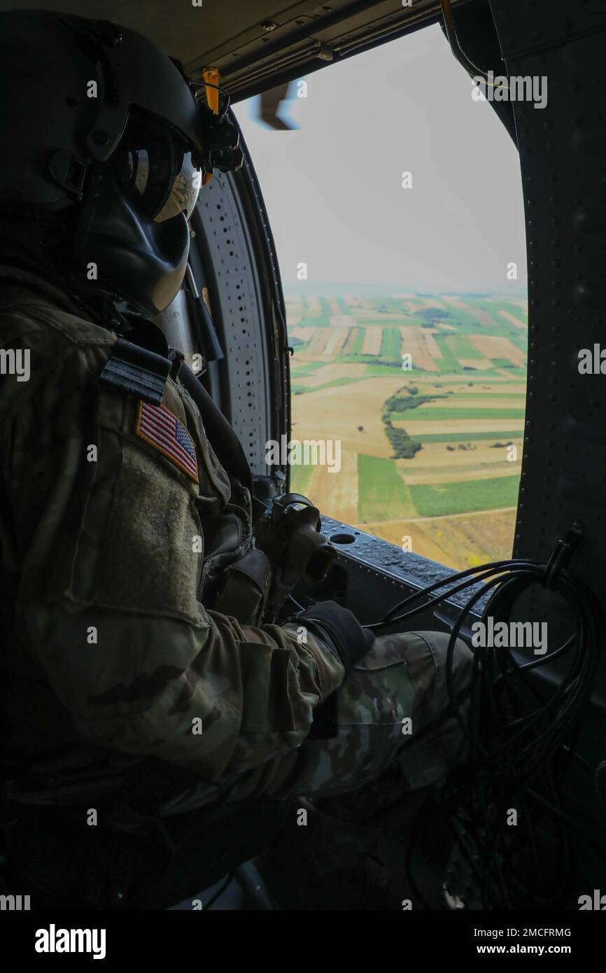 U.S. Army Soldiers from Task Force Pegasus conduct an air assault operation with multi-national partners from the Republic of Latvia and the Republic of Poland, in Kosovo June 30, 2022. Interoperability improves the Arm's ability to operate effectively and efficiently as a component of the Combined Force across a wide range of military operations. U.S. Army National Guard photo by SGT. Alexander Hellmann Stock Photo
