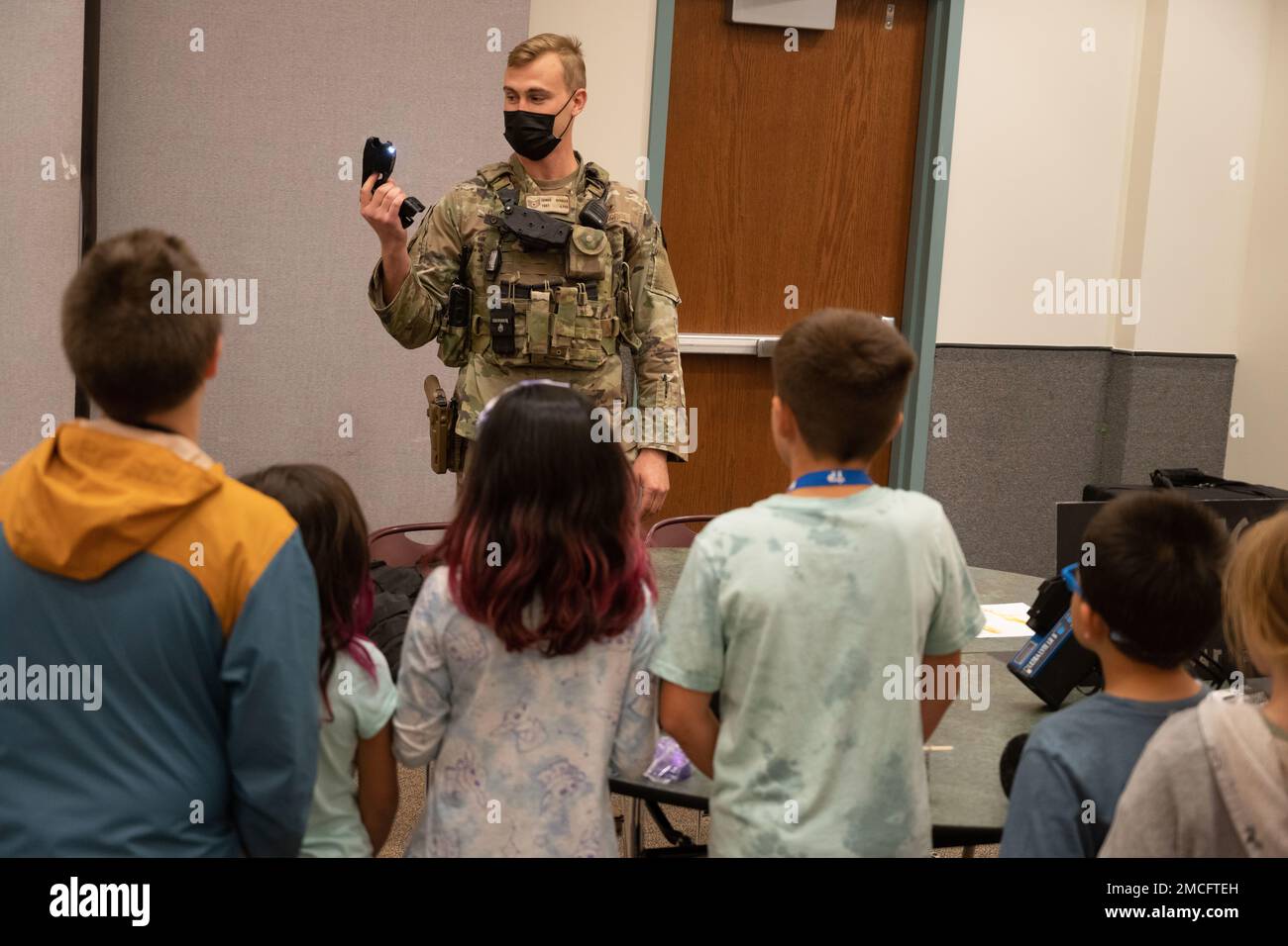 A 460th Security Forces Guardian demonstrates the use of a taser to the children of Team Buckley.  The Buckley School Liaison hosts the first Buckley STEM day to give the children of Team Buckley an opportunity to get hands-on with Science, Technology, Engineering, Math-related fields at Buckley Space Force Base, Aurora,    Colorado, June 30, 2022. Stock Photo