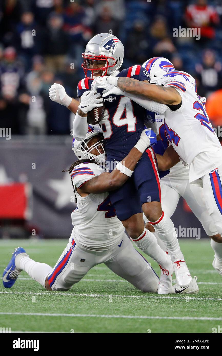 New England Patriots' Kendrick Bourne is stopped by the defense of New  England Patriots long snapper Joe Cardona, left, and Taron Johnson during  an NFL football game at Gillette Stadium Sunday, Dec.