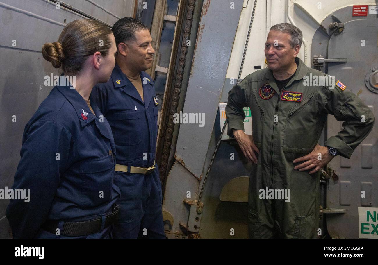 220701-N-QI593-1105 ADRIATIC SEA (July 1, 2022) Rear Adm. Paul Spedero, commander, Carrier Strike Group 8, right, speaks with Sonar Technician (Surface) 1st Class Jacquelyn Sawyer, left, from Detroit, and Chief Logistics Specialist Omar Gallardo, from Newark, New Jersey in the hangar bay aboard USS Bainbridge (DDG 96) in the Adriatic Sea, July 1, 2022. Bainbridge is on a scheduled deployment in the U.S. Naval Forces Europe area of operations, employed by U.S. Sixth Fleet to defend U.S., allied and partner interests. Stock Photo