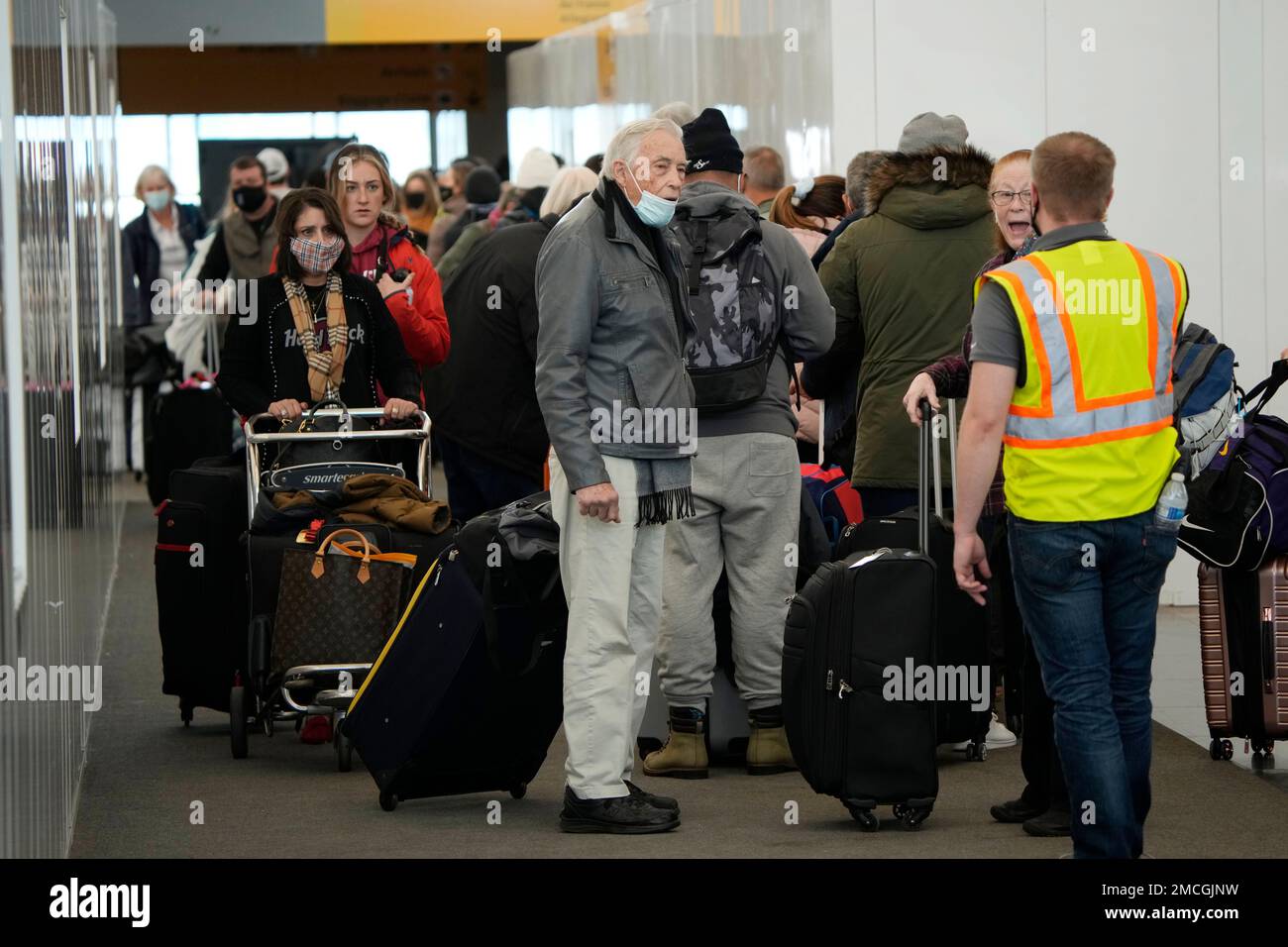 Passengers queue up to check in at the counter for Delta Airlines