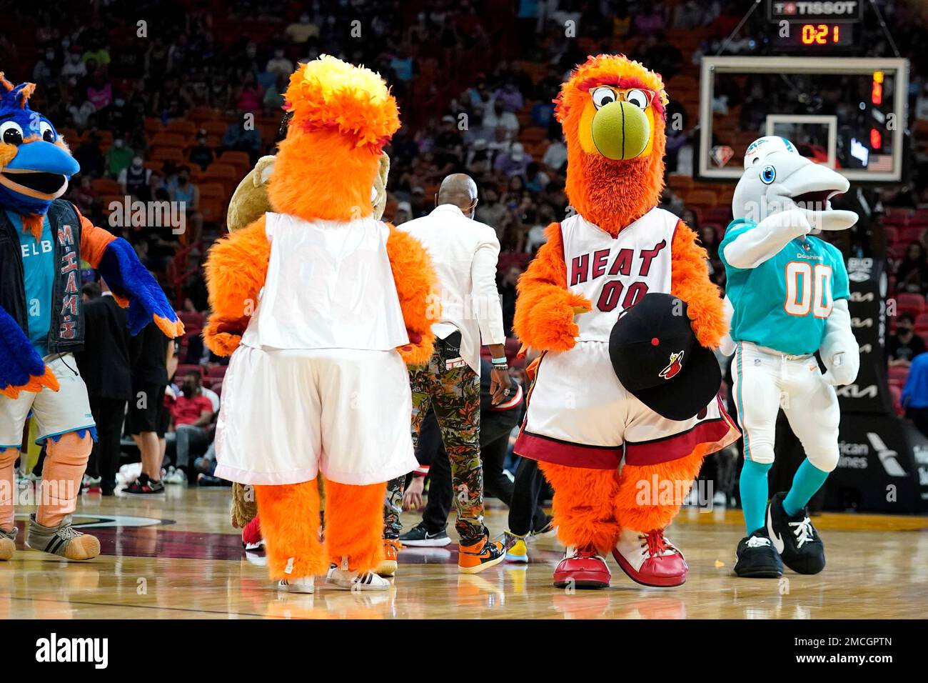 The Miami Heat mascot Burnie, second from right, stands on the court