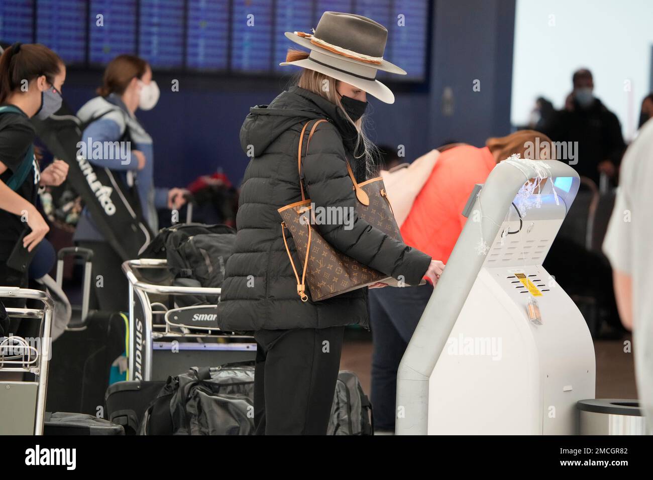 Passenger uses the selfservice kiosk to check in at the counter for Southwest Airlines Monday