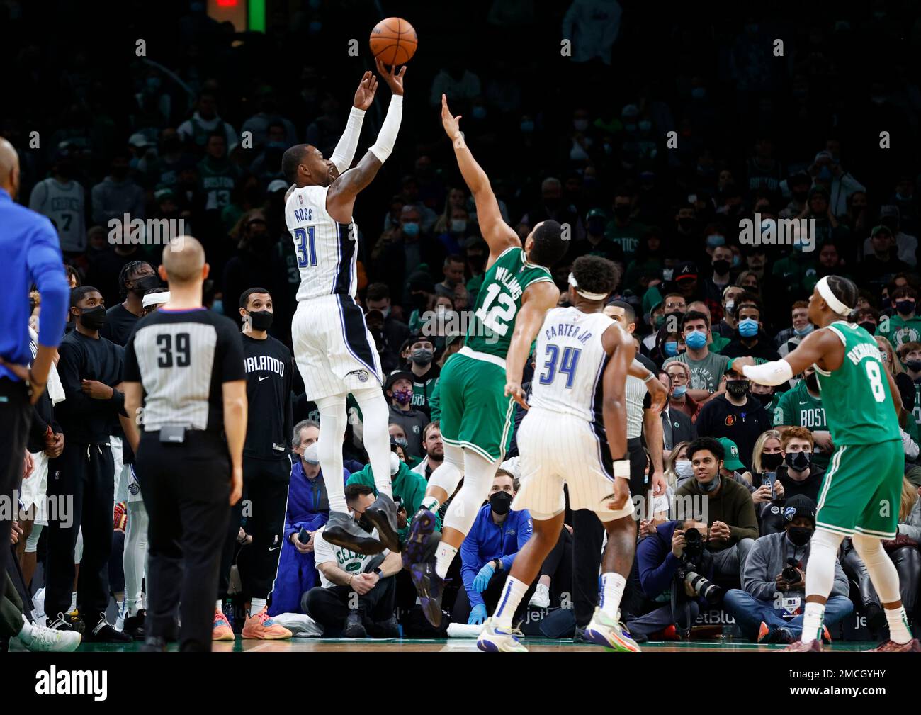 Orlando Magic guard Terrence Ross (31) is fouled by Boston Celtics forward Grant Williams (12) as he shoots a three-point shot during overtime of an NBA basketball game, Sunday, Jan