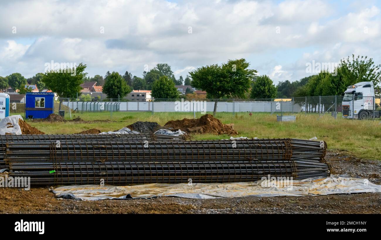 A stack of flight auger piles lay on a construction site, so that contractors can build the foundations of a water reservoir, on Chièvres Air Base, Belgium, July 07, 2022. Stock Photo