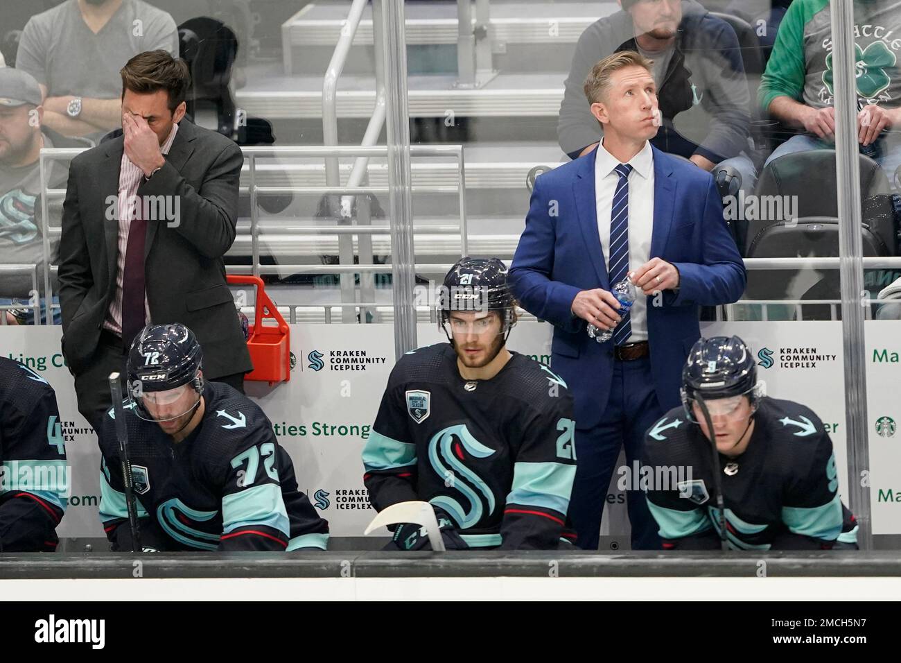 Seattle Kraken coach Dave Hakstol, right, and assistant coach Jay Leach, left, stand behind the bench during the third period of the team's NHL hockey game against the Vancouver Canucks, Saturday, Jan. Seattle Kraken coach Dave Hakstol, right, and assistant coach Jay Leach, left, stand behind the bench during the third period of the team's NHL hockey game against the Vancouver Canucks, Saturday, Jan.