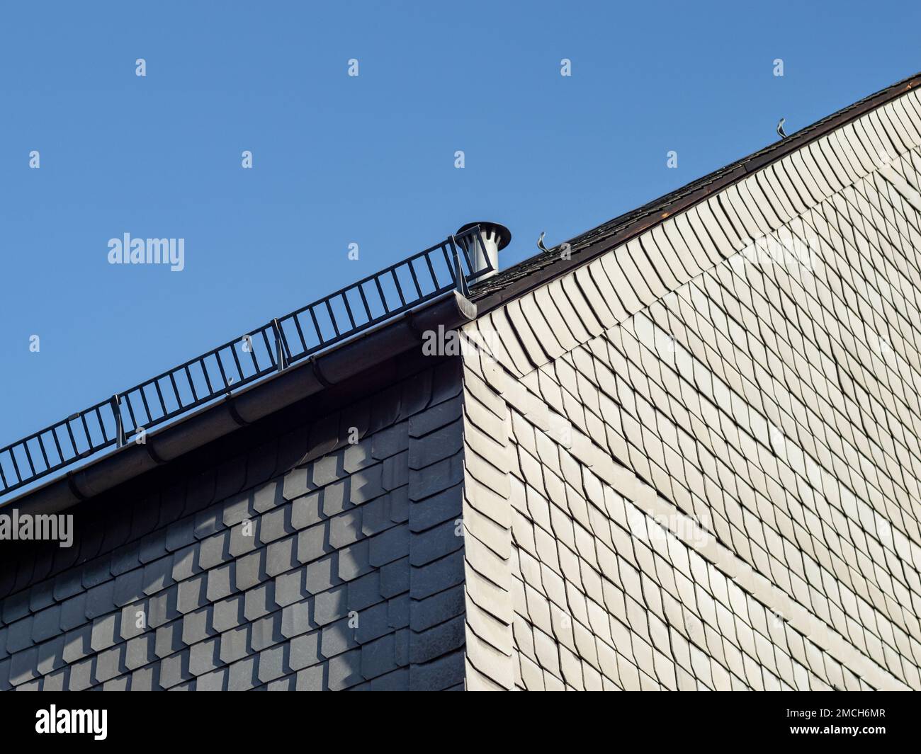 Asbestos facade of a residential building in East Germany. Grey fibrous