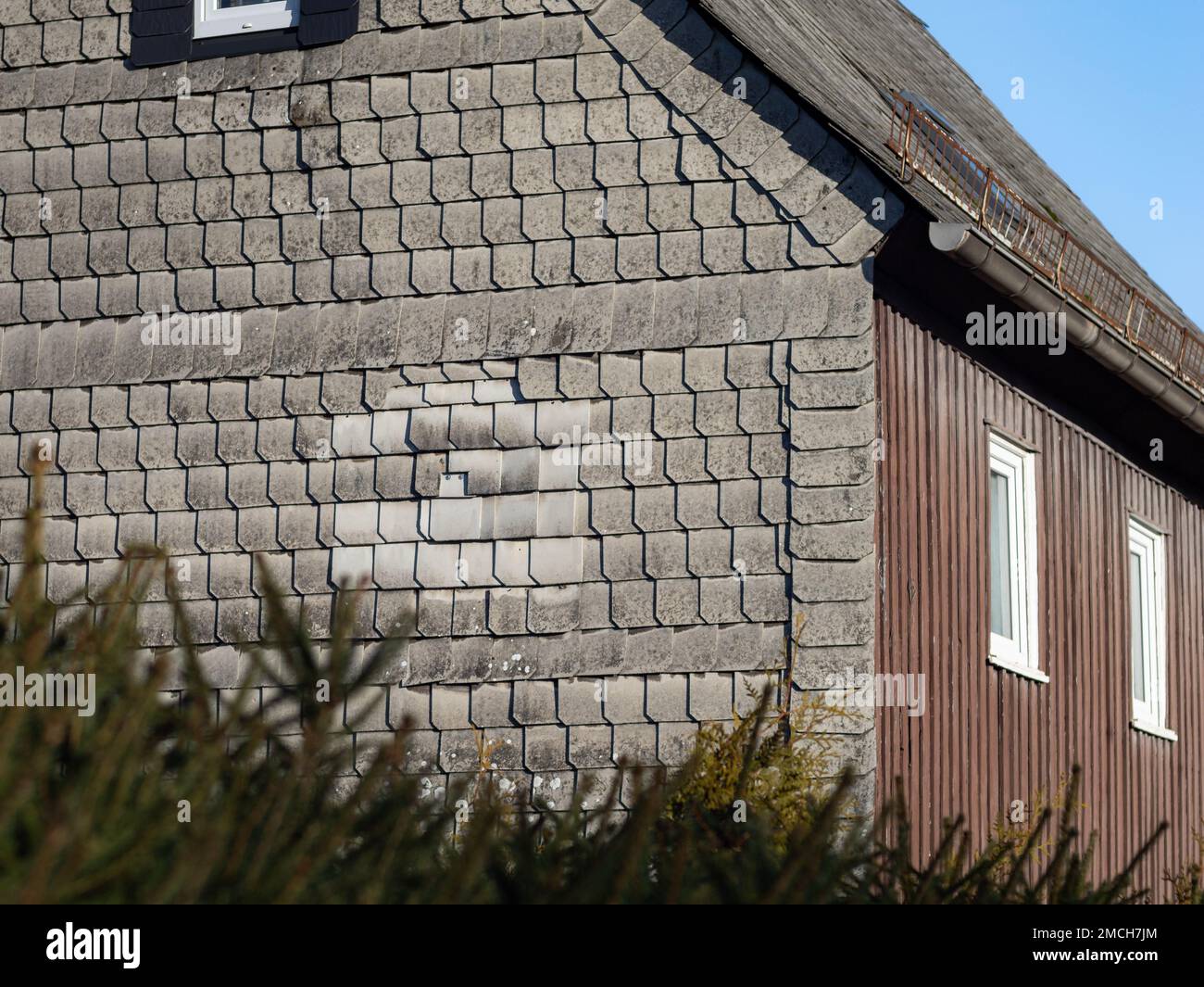 Asbestos wall cladding on an old building facade. Exterior of a