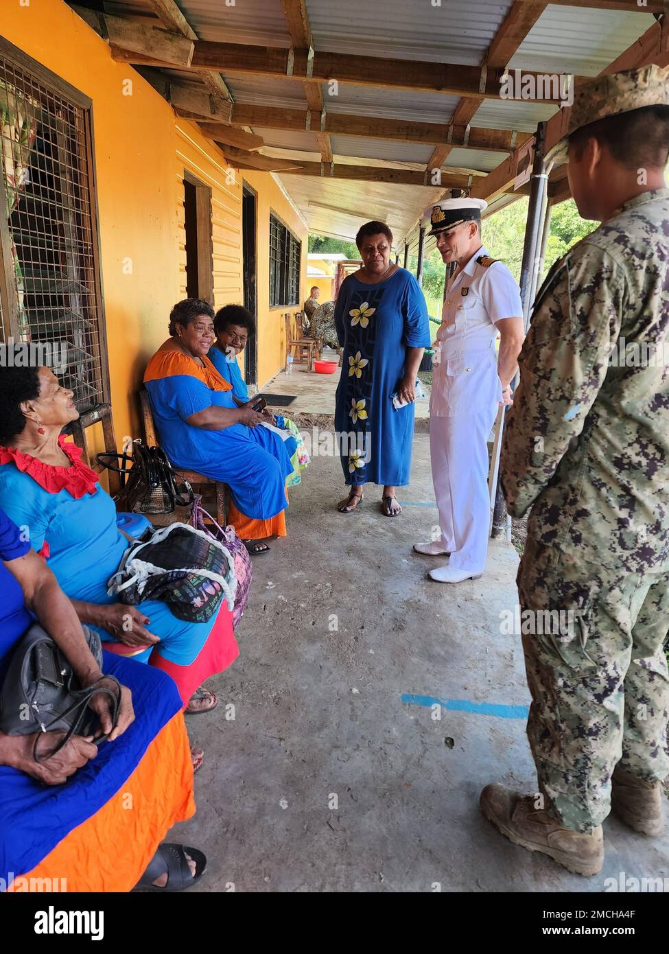 FIJI (July 2, 2022) – Captain Kerri Harris, of the U.K. Royal Navy serving as the U.S. Pacific Fleet Director for Humanitarian Assistance/Disaster Relief and Combined Operations, speaks with Fiji natives at the Navonu Primary School constructed by U.S. Navy Seabees assigned to Naval Mobile Construction Battalion THREE (NMCB3) and Republic of Fiji Military Forces (RFMF) Engineers in support of Pacific Partnership 2022. Now in its 17th year, Pacific Partnership is the largest annual multinational humanitarian assistance and disaster relief preparedness mission conducted in the Indo-Pacific. Stock Photo