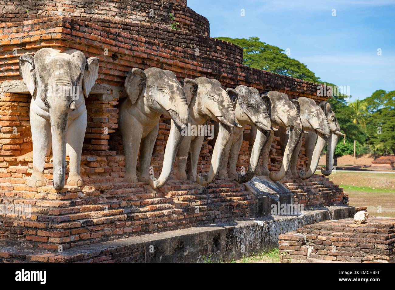 Restored old elephant sculptures ont the ruins of the ancient Buddhist