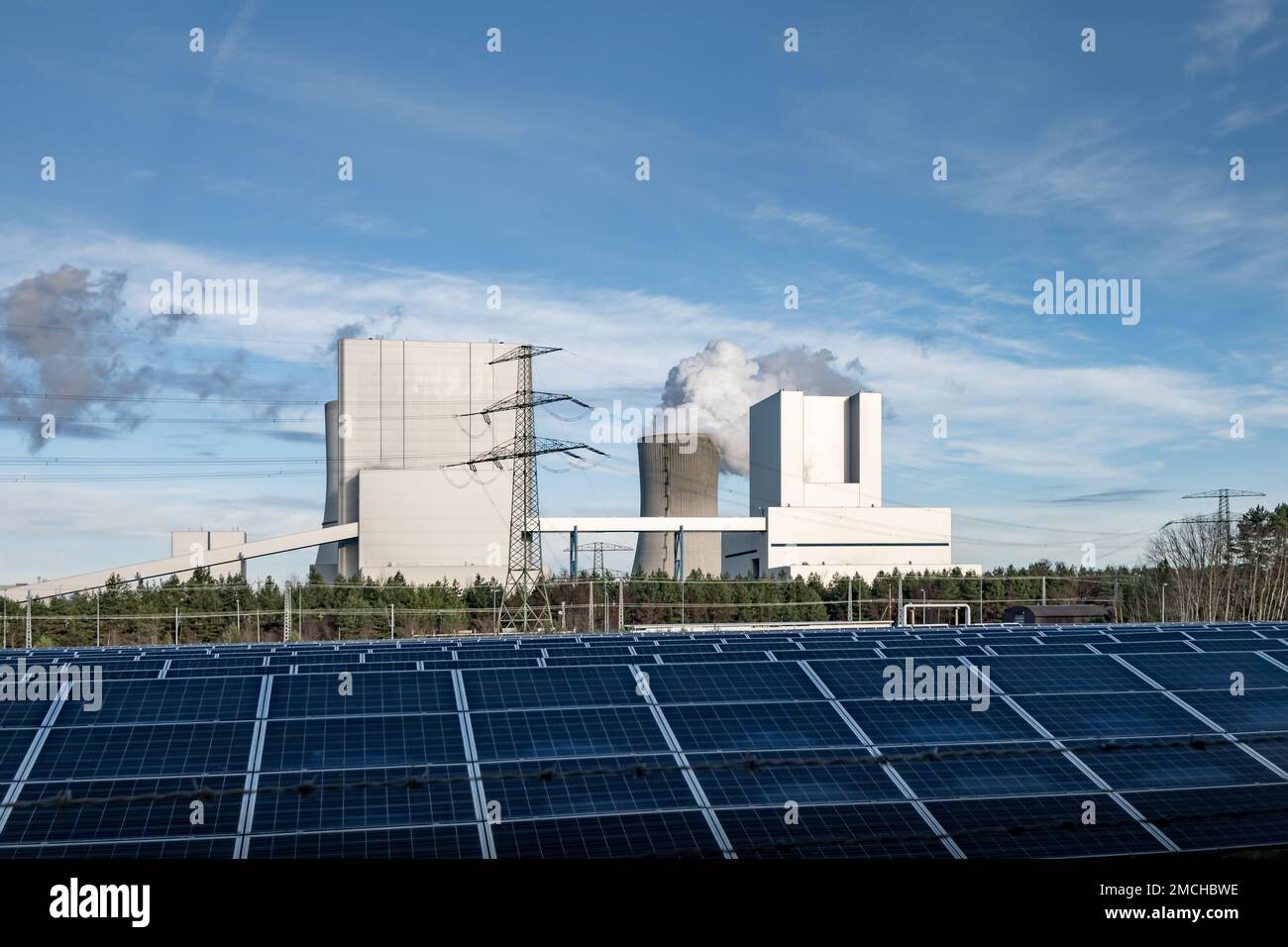 Boxberg lignite power plant with solar cell panels in front. Fossil fuels versus renewable energy. The energy turnaround in Germany is a revolution. Stock Photo