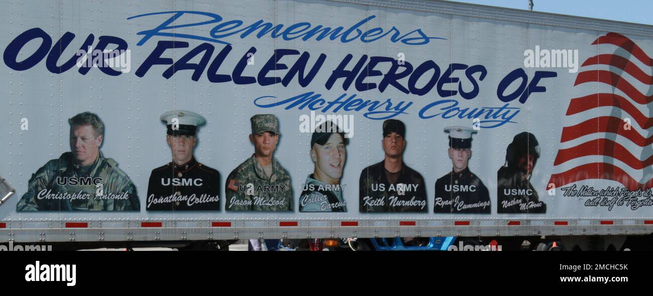 A truck trailer shows the faces of the military members from McHenry