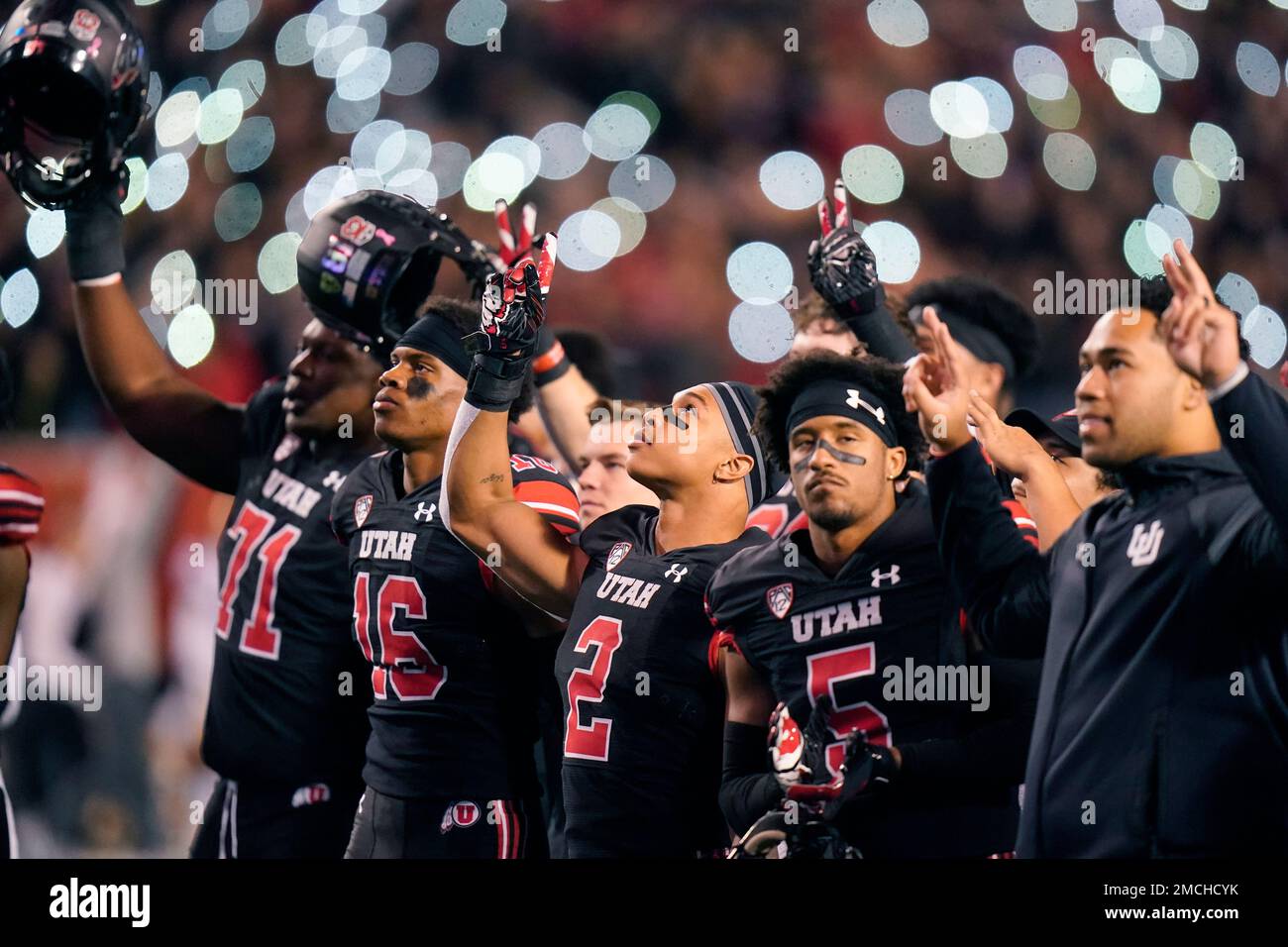 FILE - Utah players remove their helmets and point skyward to honor Ty  Jordan and Aaron Lowe during the second half of an NCAA college football  game against UCLA Saturday, Oct. 30,