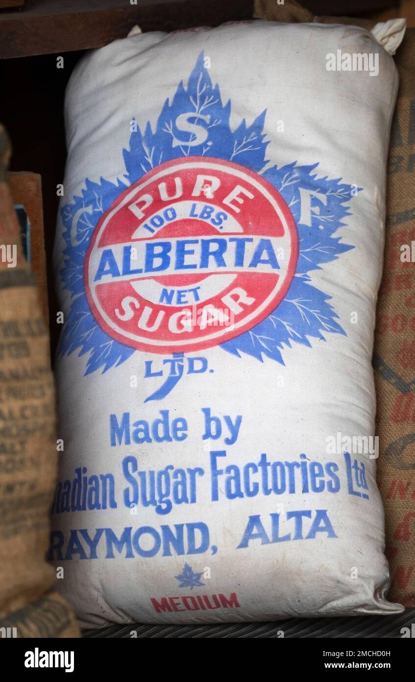 Vintage sack of sugar weighing 100 lbs made in Raymond, Alberta, Canada on display in an old storeroom at Bar U Ranch National Historic Site Stock Photo